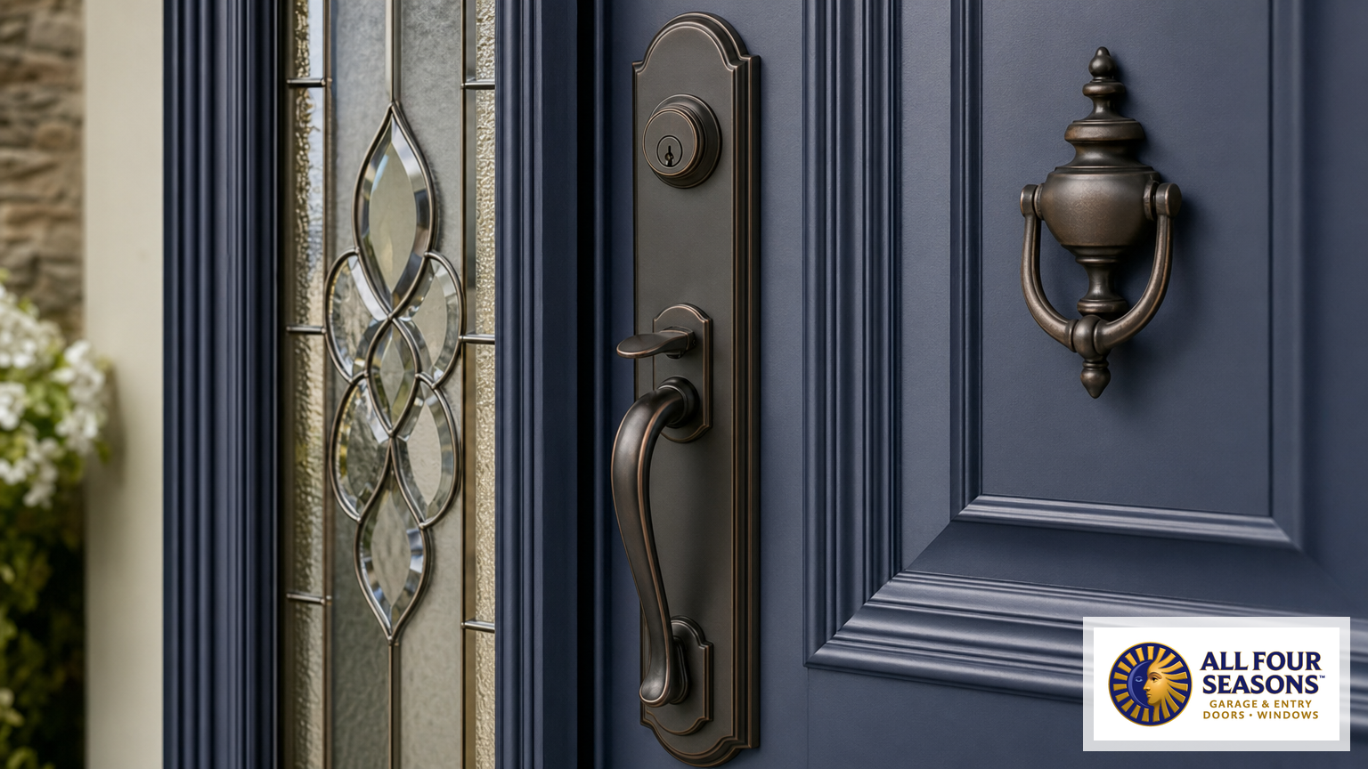 Premium door hardware and decorative glass sidelight details on a navy blue entry door
