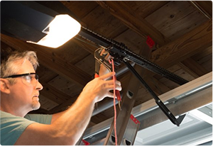 man fixing garage door opener